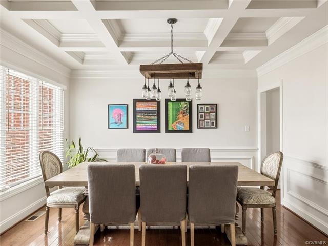 Formal dining room with coffered ceiling and custom chandelier