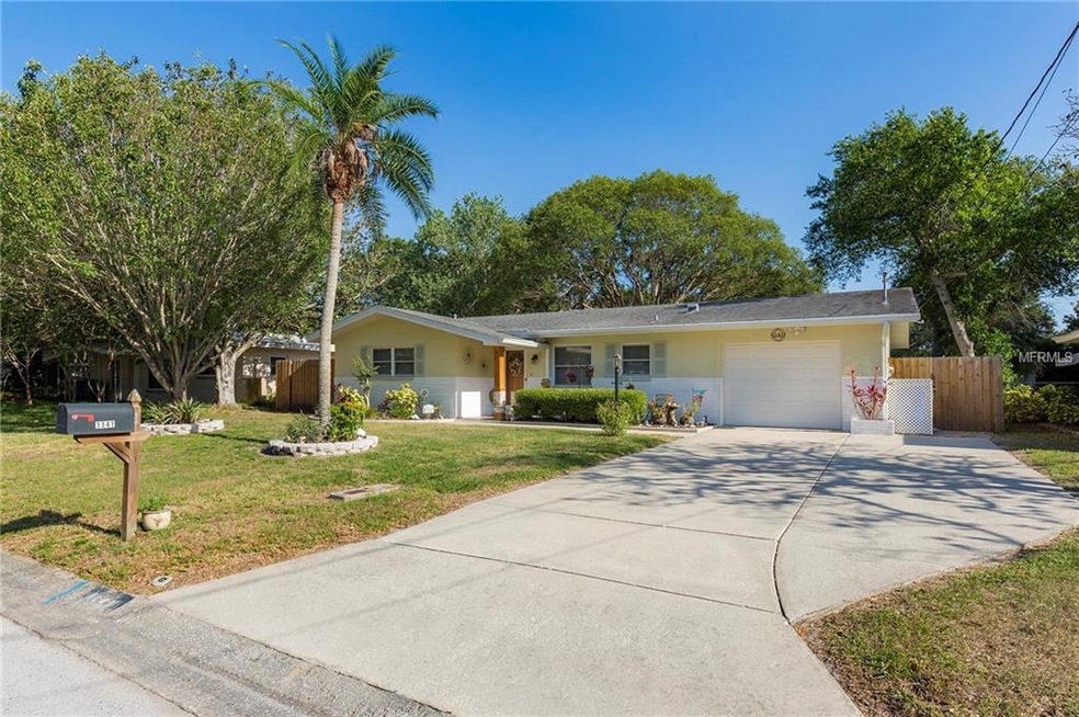 Front exterior with extra parking pad on the right