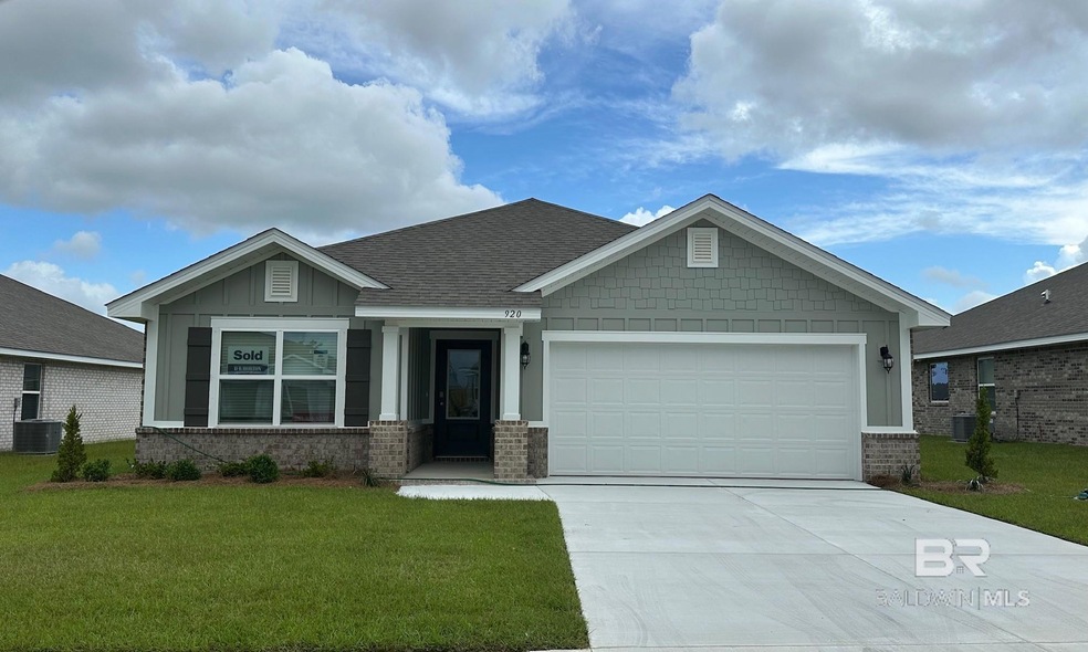 Craftsman-style home with a front lawn and a garage