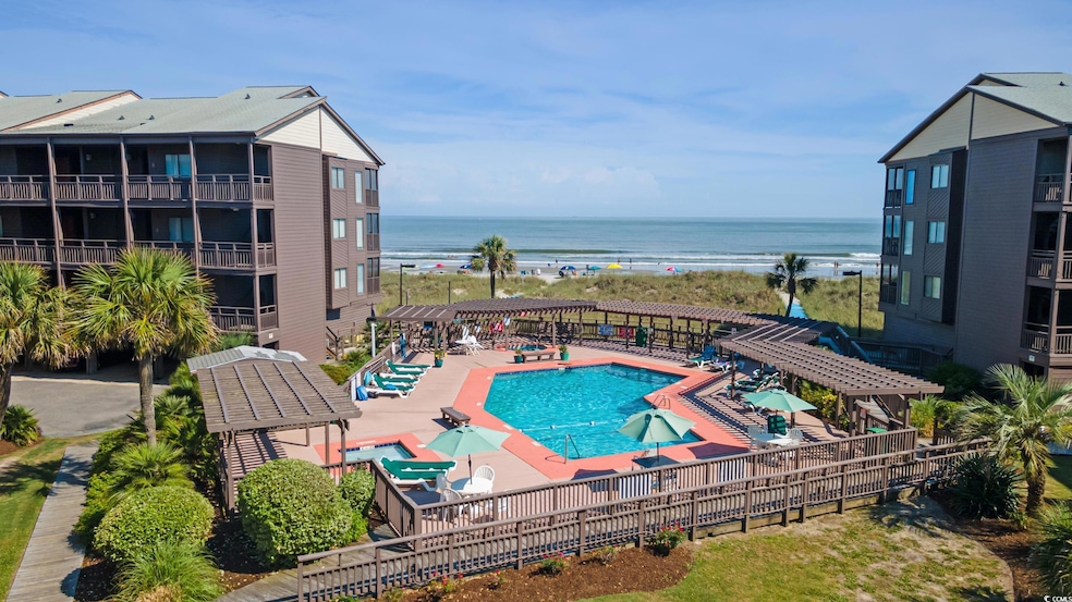 Community pool with a water view and a pergola