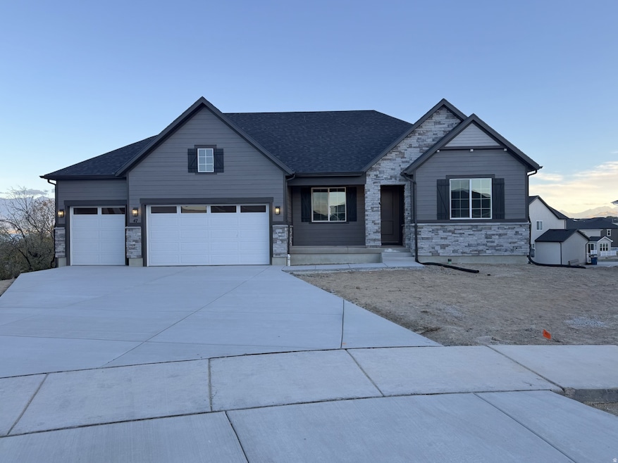 View of front of home with stone siding, driveway, roof with shingles, and an attached garage