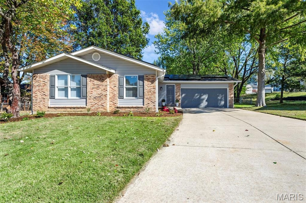 Ranch-style house featuring a front lawn, brick siding, concrete driveway, and a garage