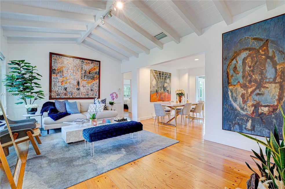 Welcoming living room with vaulted wood ceilings, hand-pegged wood floors and art deco fireplace open to Dining room, kitchen and FR/sunroom