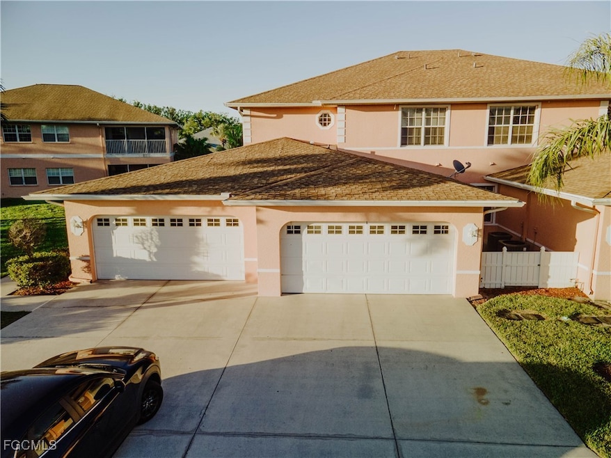 View of front of property with stucco siding, concrete driveway, an attached garage, and a shingled roof