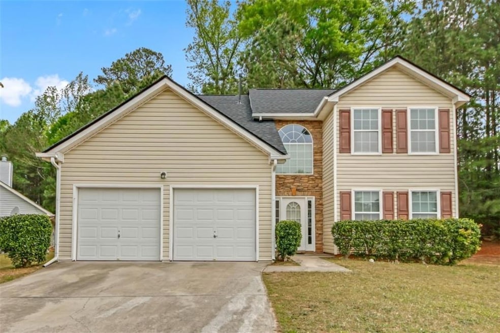 Traditional home featuring an attached garage, a s