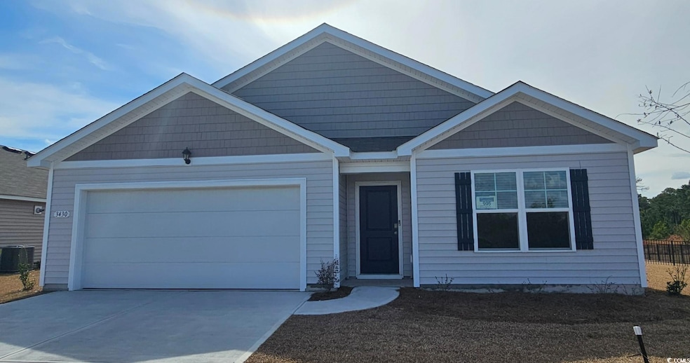 View of front of property featuring a garage, driv