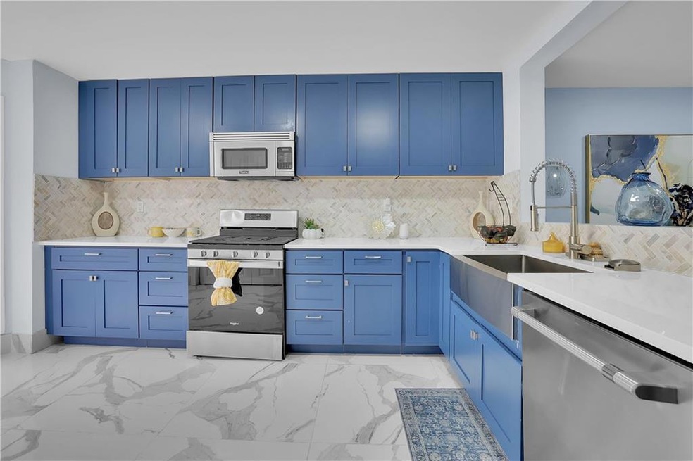 Kitchen featuring blue soft-close cabinets, farm s