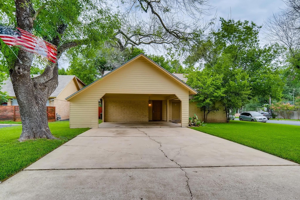 View of front of home with driveway and brick sid