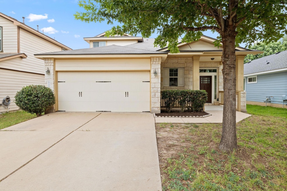 View of front of property featuring a garage, dri
