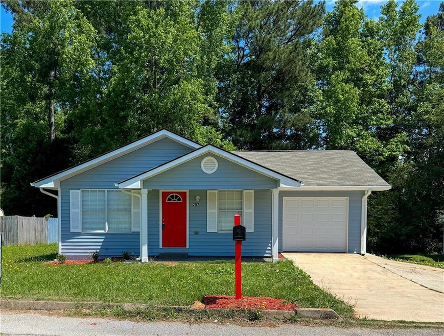 Ranch-style home with a front yard and a garage