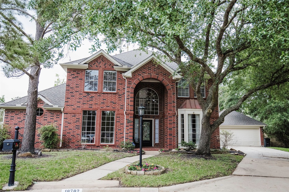 Traditional red brick exterior with arched entrywa