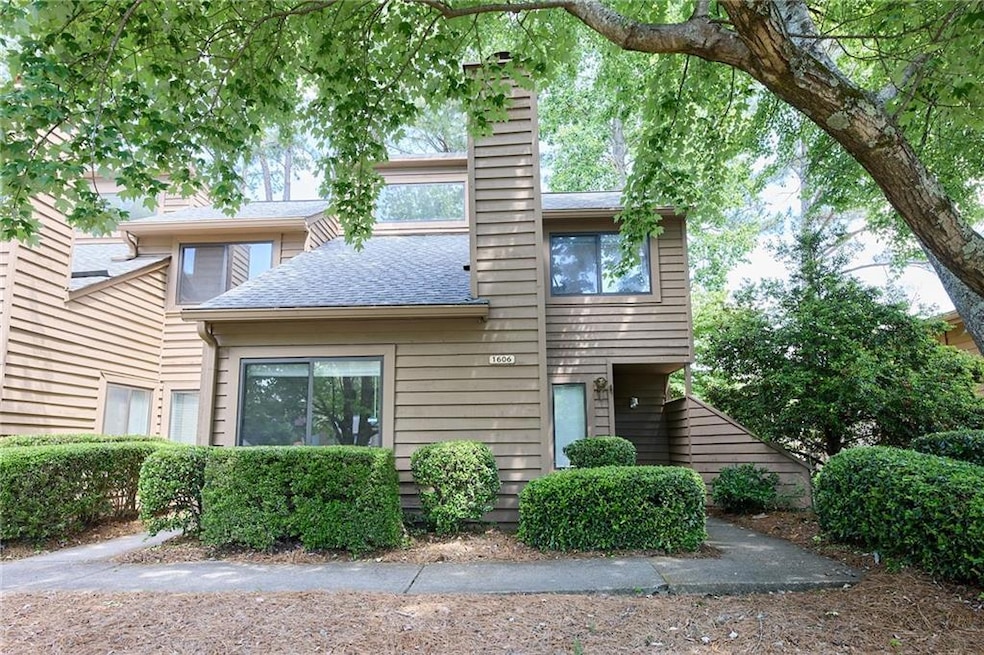 View of front of home featuring a chimney and roof