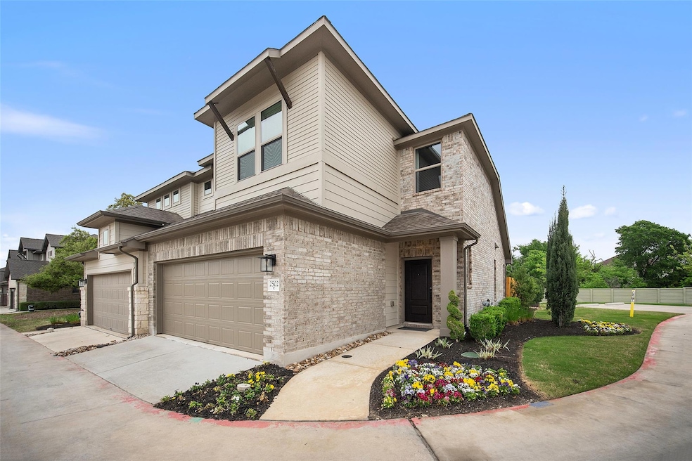 View of front of home featuring a garage, fence, 
