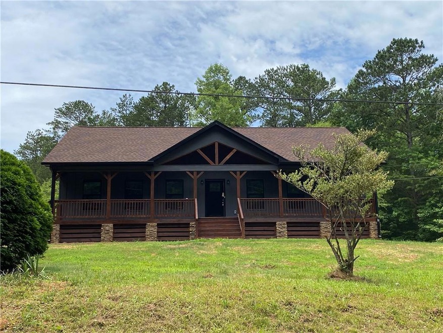 View of front facade featuring a front lawn and a porch