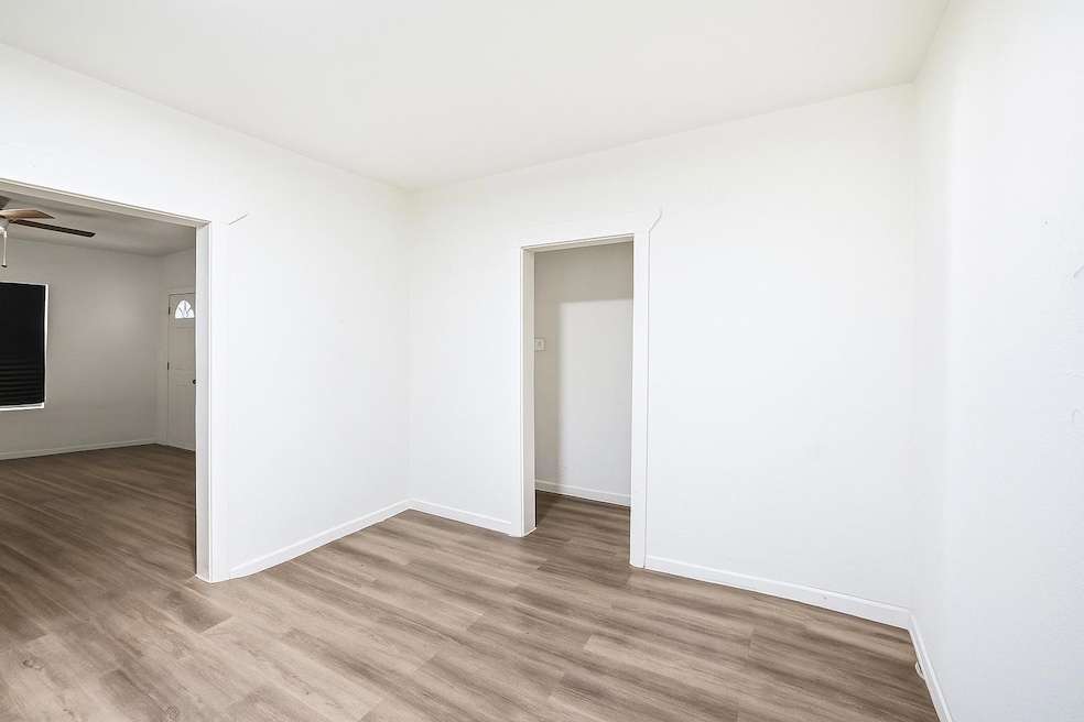 Spare room with wood finished floors and ceiling fan