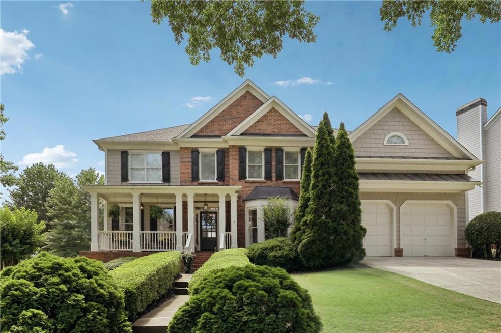 View of front facade featuring a garage, a front y