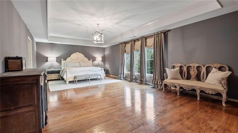Dreamy master with trey ceiling, custom drapes, an