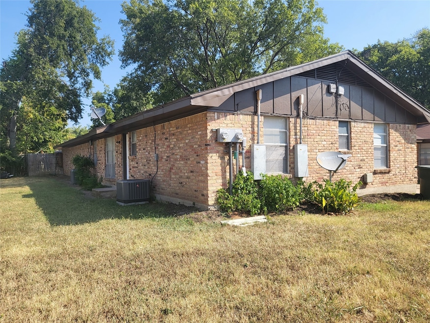 View of property exterior featuring board and batten siding and brick siding