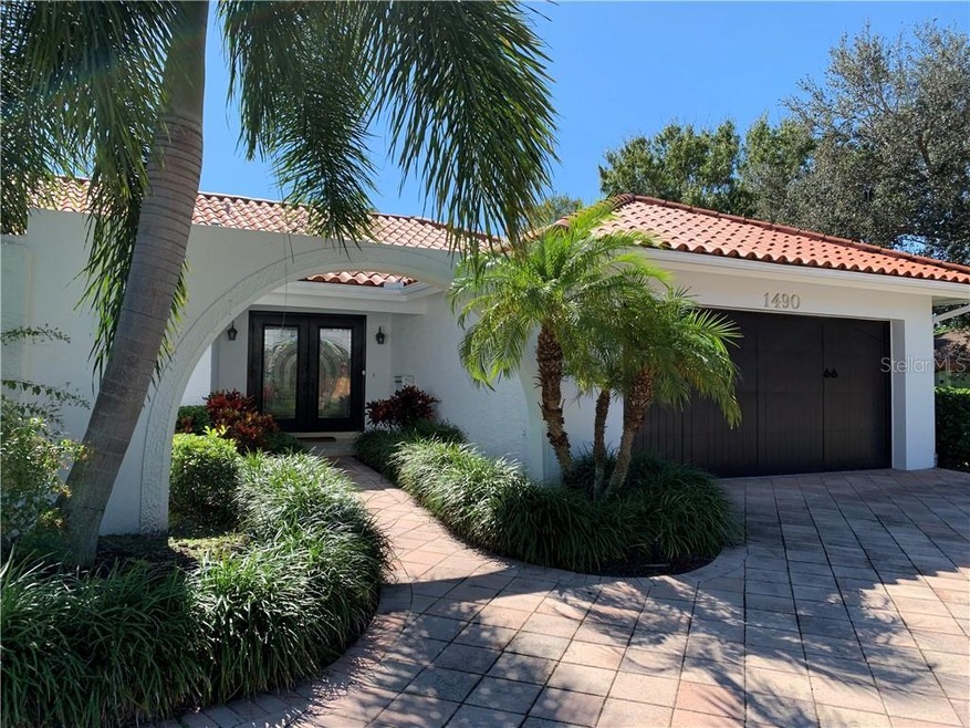 Mature palm trees surround the home