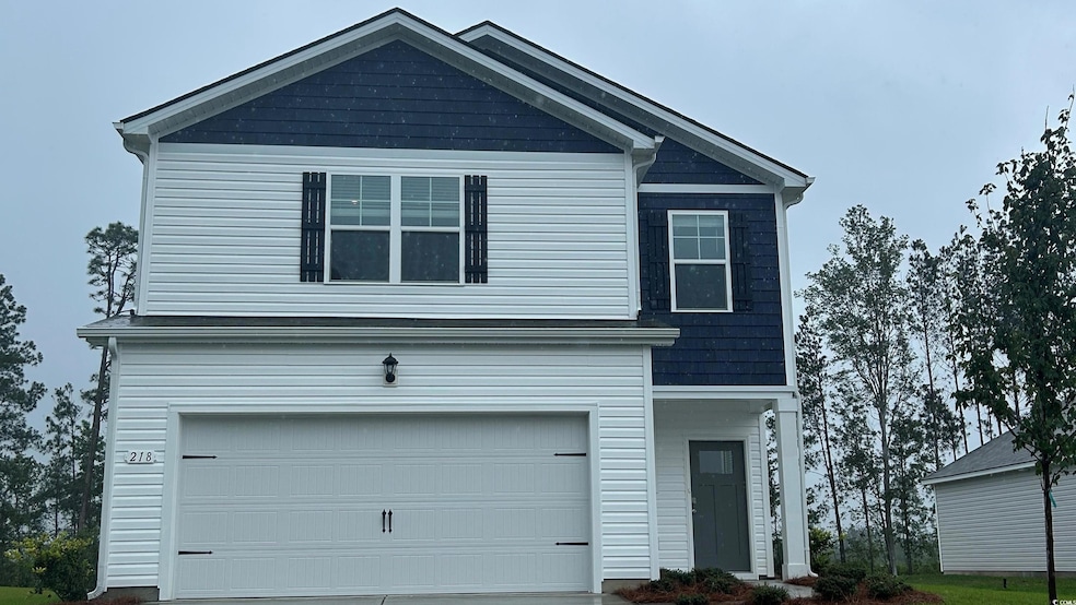 View of front facade with an attached garage and driveway
