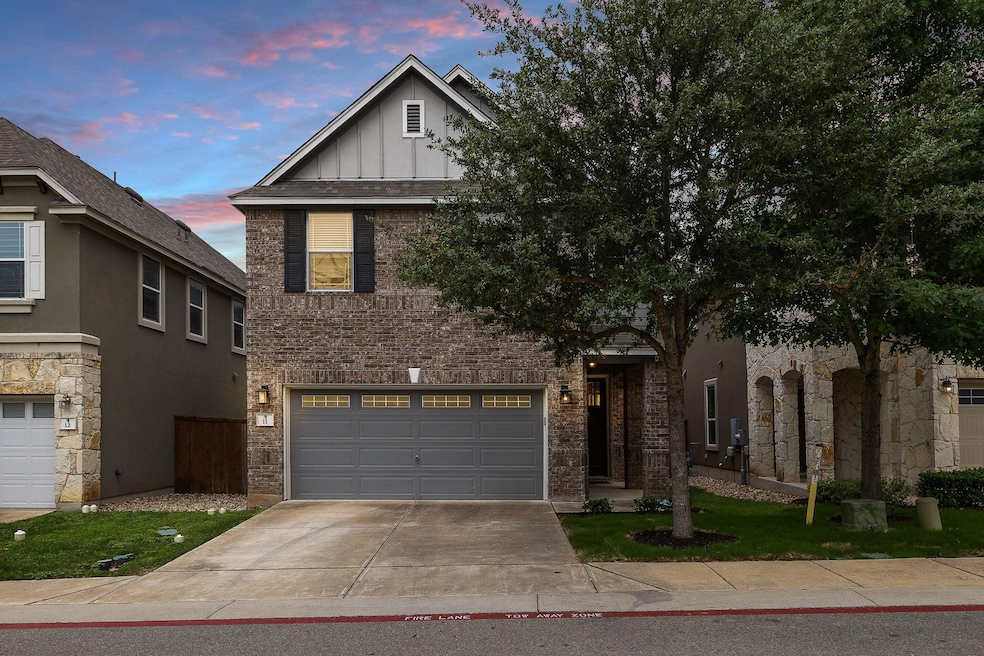 Traditional home featuring concrete driveway, boa