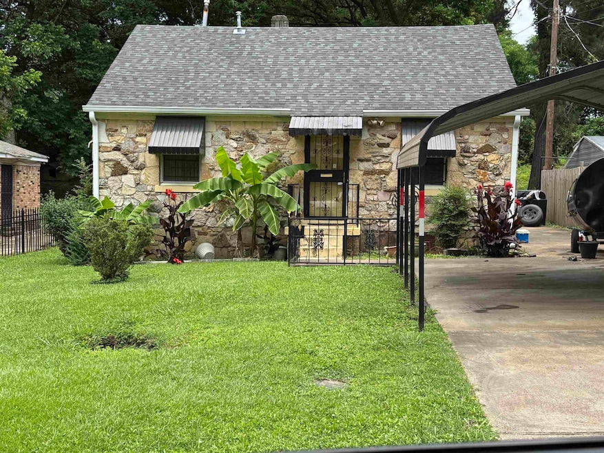 View of front facade featuring stone siding and roof with shingles