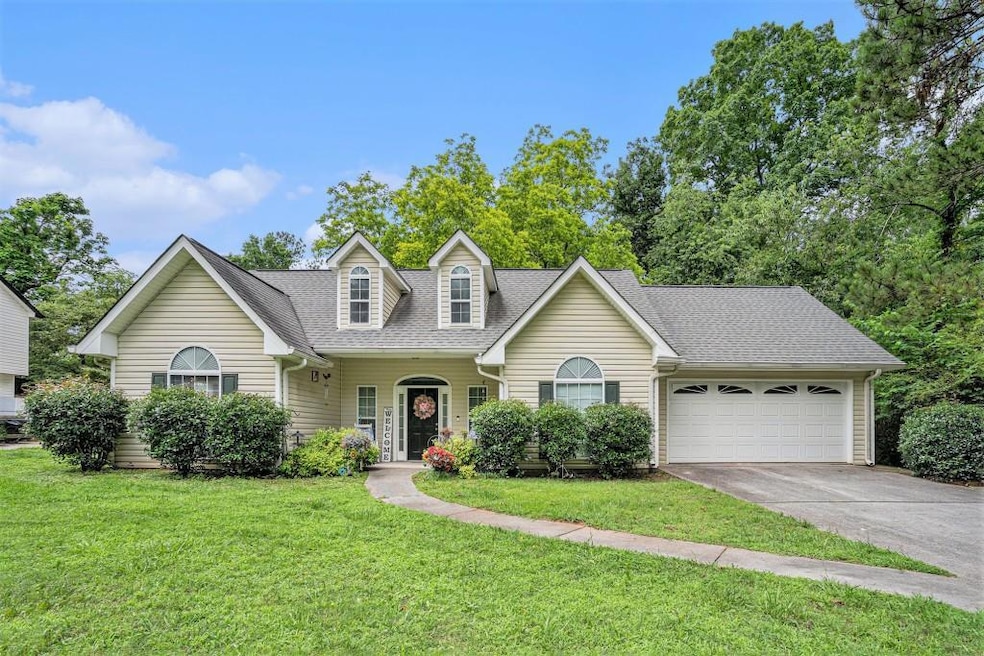 RANCH HOME WITH FRONT PORCH AND LOW MAINTENANCE VINYL SIDING.
