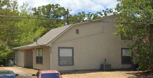 View of side of home with a patio, central AC unit