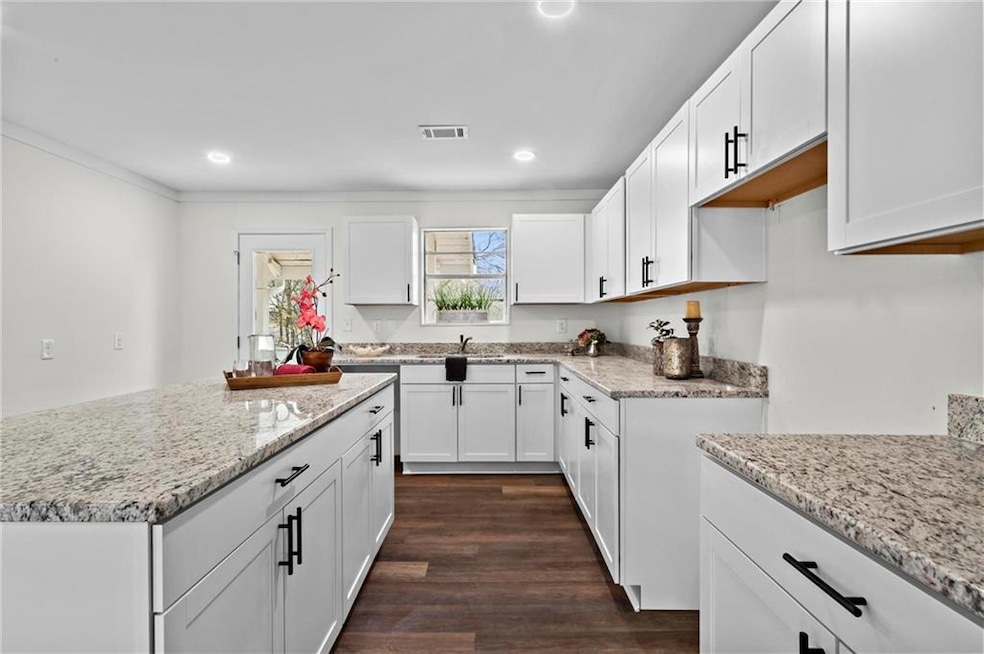 Modern and sleek open-concept kitchen featuring li