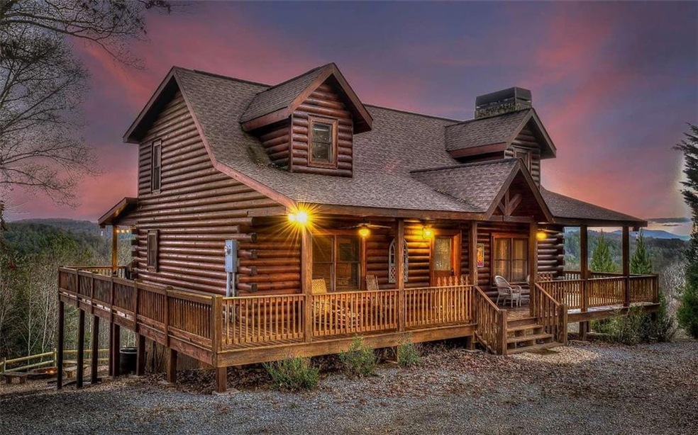 Log-style house featuring a wooden deck