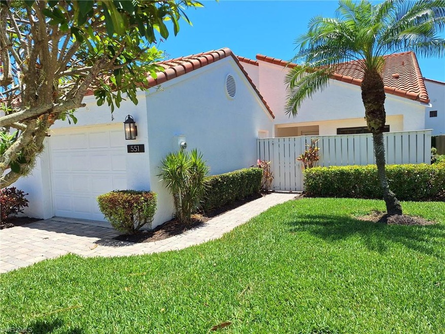 View of home's exterior featuring a garage and a yard