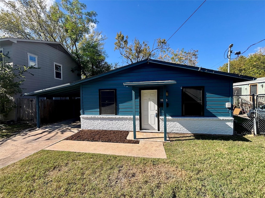 View of front of property featuring a carport and driveway