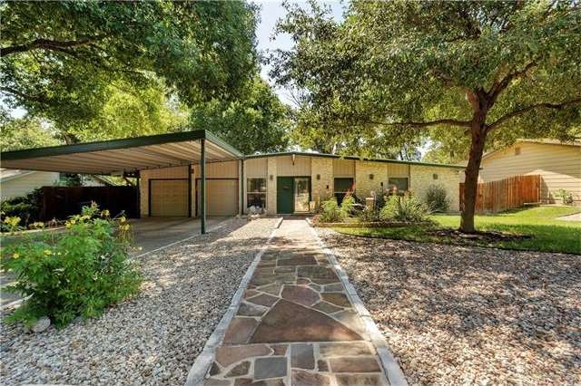 Exterior front. 2 car garage with carport