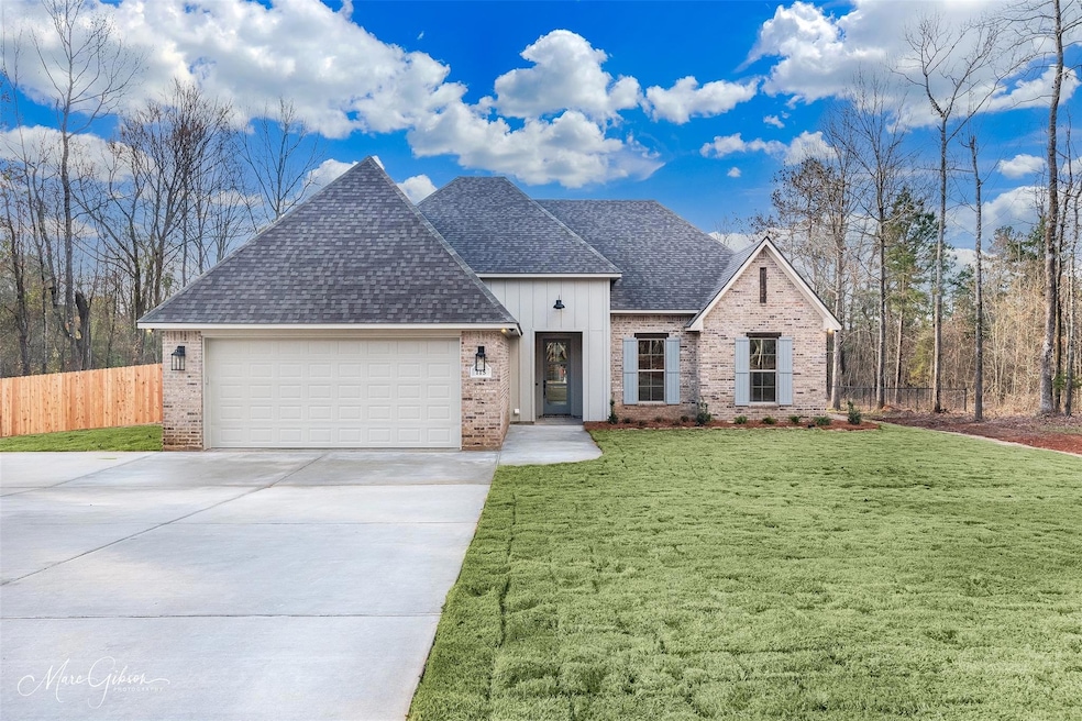 View of front of home with a garage and a front la