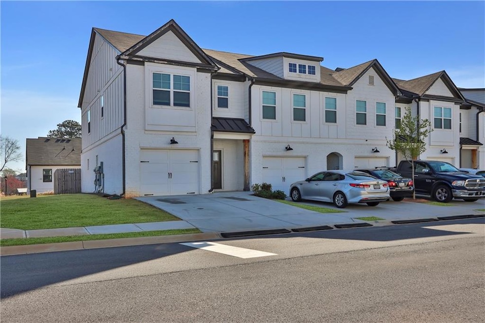 View of property featuring an attached garage, a f