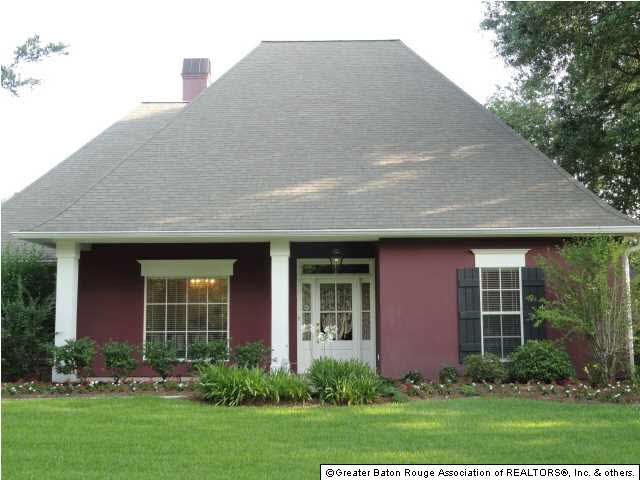 The front porch leads to a gracious entry with woo