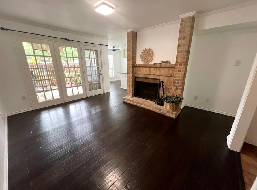 Unfurnished living room with baseboards, dark wood