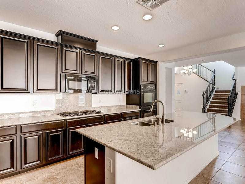 Property Photo. Stunning dark wood cabinets with l