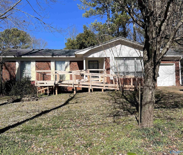 Full brick home on large corner lot with trees.