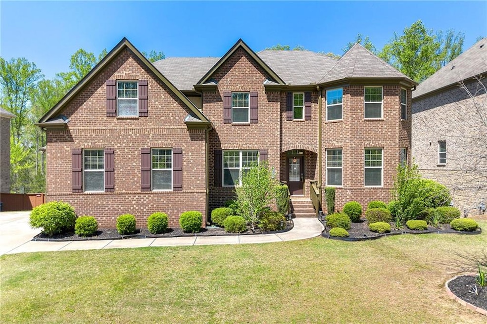 View of front of house with a front lawn and brick