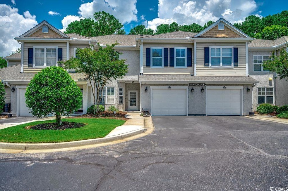 Townhome / multi-family property with driveway, an attached garage, and roof with shingles
