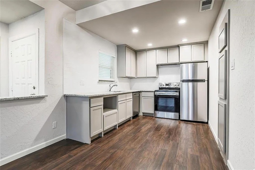 Kitchen featuring sink, dark hardwood / wood-style
