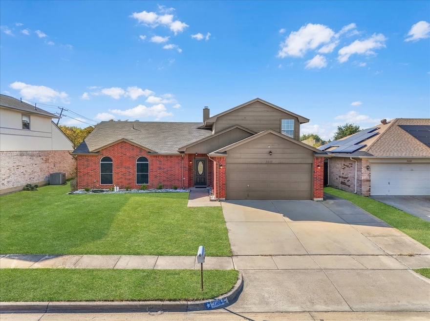 Traditional home with roof with shingles, driveway, a front lawn, and brick siding