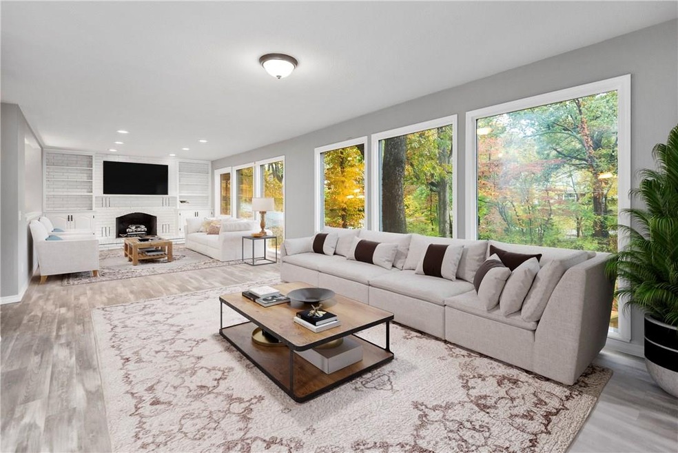 The large, open living room with gas log fireplace offers the serenity of living in a tree house.