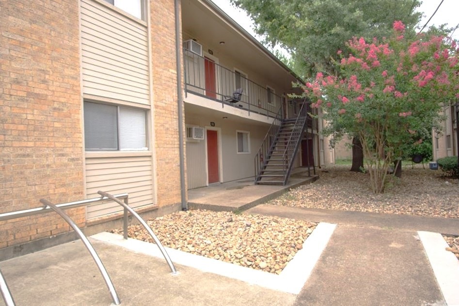 View of building exterior with stairs and a wall m