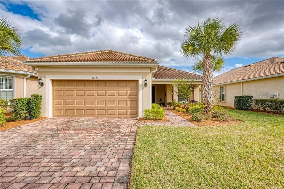 Front of home with paver driveway