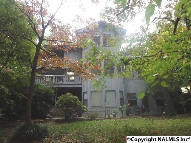 Three stories, multiple decking, stone patio. 4 bedrooms, 3.5 baths.  Peaceful and private, yet convenient to everything. You must see this home to appreciate it.