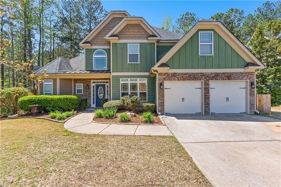 Craftsman-style house with an attached garage, sto