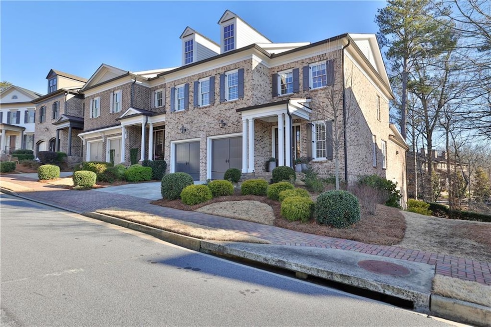 Light-filled brick townhome with front portico across from community park.