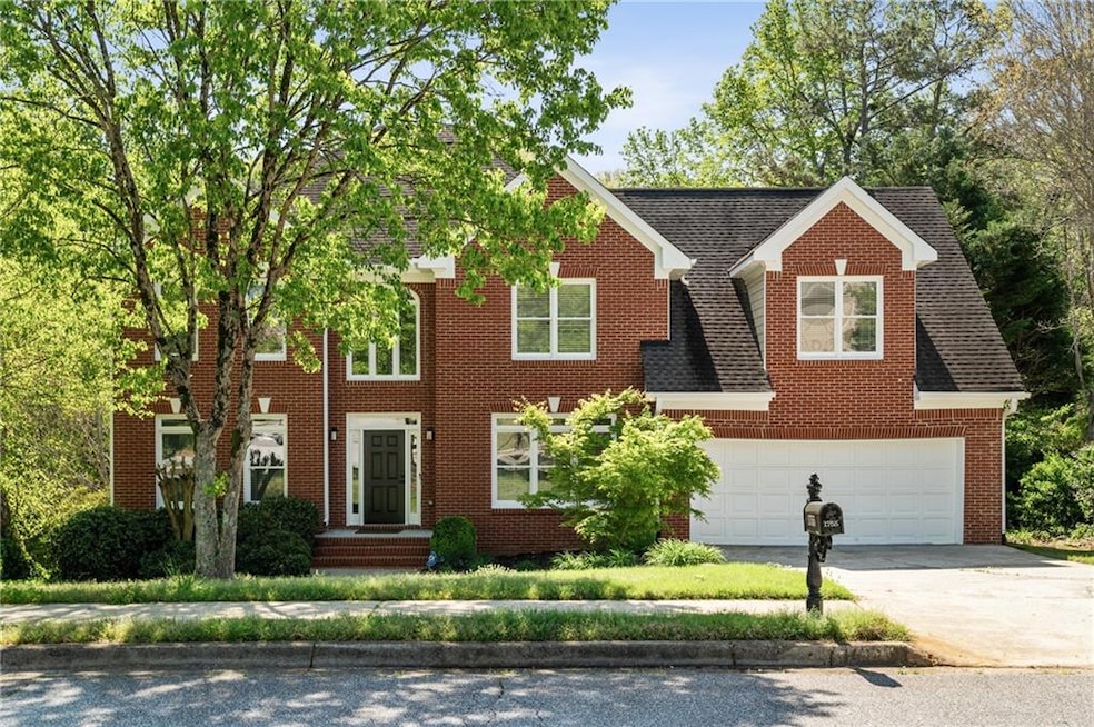 Colonial inspired home featuring brick siding, dri